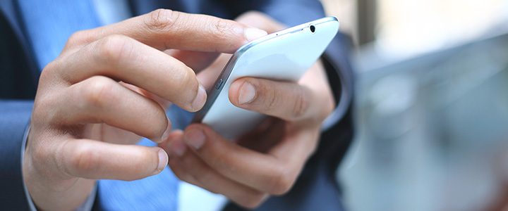 Businessman checking travel reservation on his mobile device