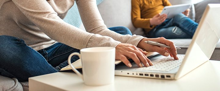 Woman using online travel agencies and other sites to research and book her family's next vacation