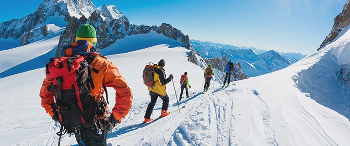 Travelers following a ski hiking trail on mountain tour
